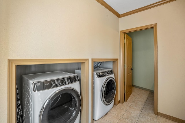 clothes washing area featuring ornamental molding, light tile patterned floors, and independent washer and dryer