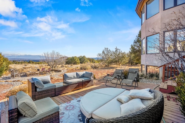 wooden terrace featuring a mountain view and outdoor lounge area