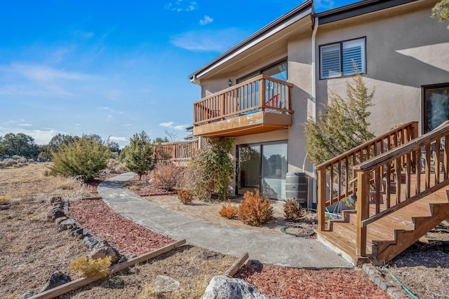 back of property with a balcony