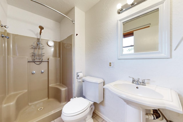 bathroom featuring toilet, walk in shower, and sink