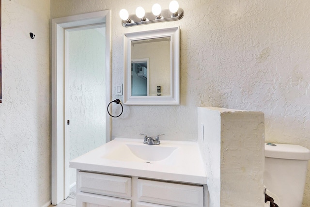 bathroom with toilet and vanity