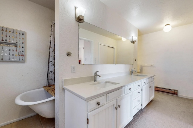 bathroom featuring baseboard heating, a bath, and vanity