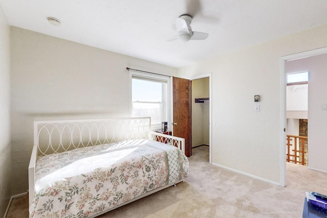 bedroom with ceiling fan and light carpet