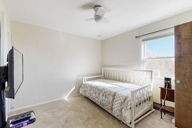 bedroom with ceiling fan and light carpet