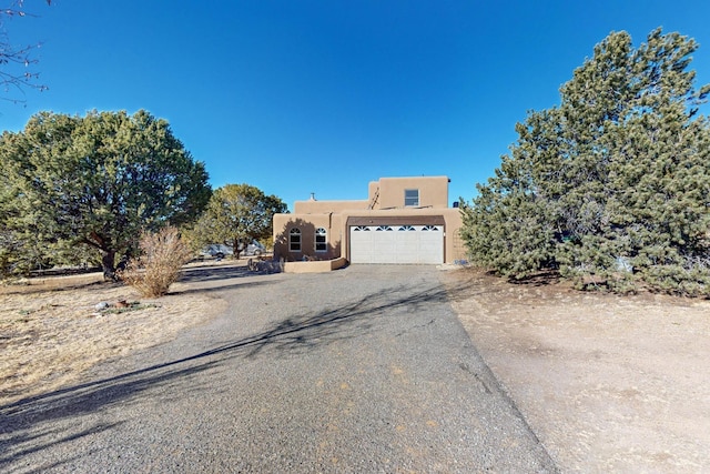 pueblo-style house with a garage