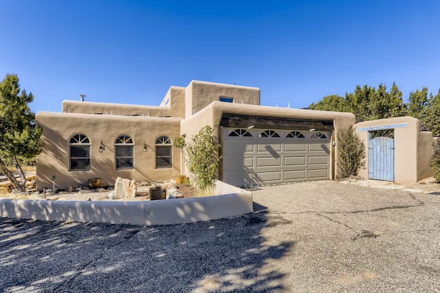 southwest-style home featuring a garage