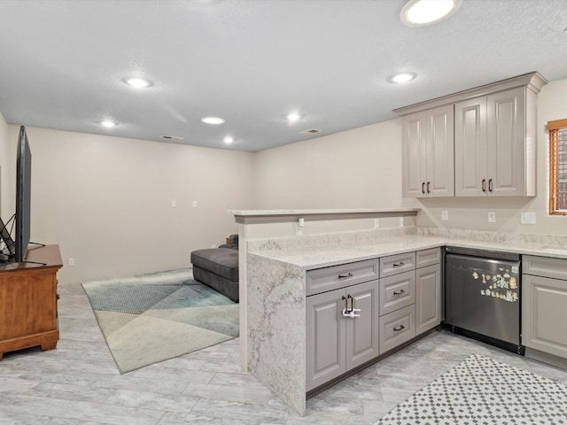 kitchen with kitchen peninsula, dishwashing machine, light stone counters, and gray cabinets