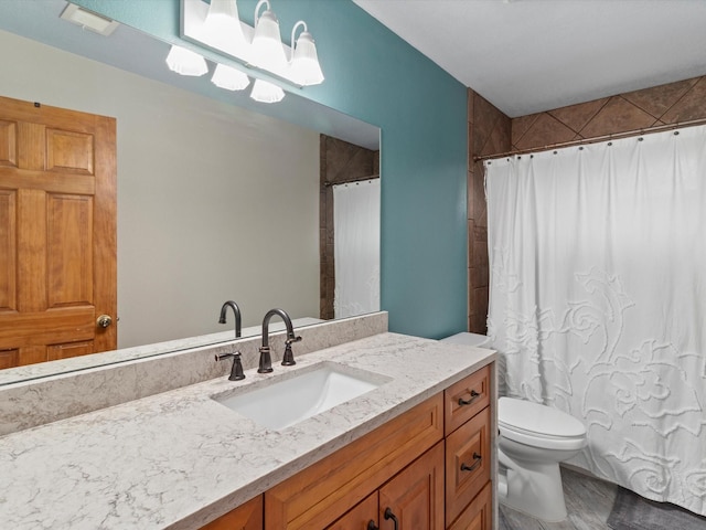 bathroom featuring toilet and vanity