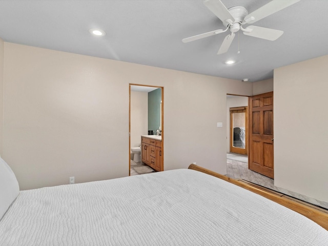 bedroom with ceiling fan, light wood-type flooring, and ensuite bath