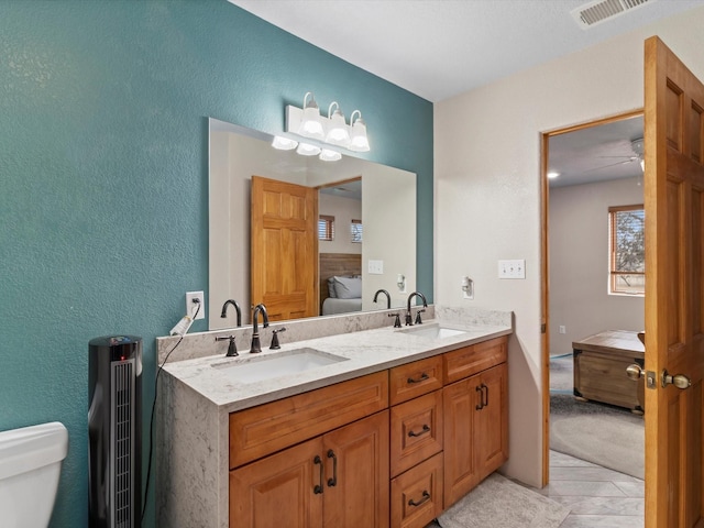 bathroom featuring toilet, ceiling fan, tile patterned floors, and vanity