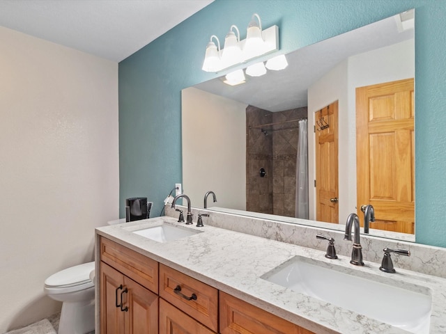 bathroom featuring toilet, curtained shower, and vanity