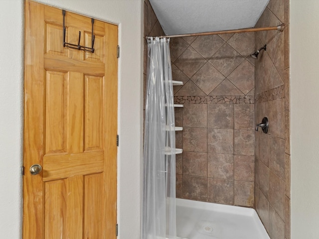 bathroom featuring a textured ceiling and walk in shower