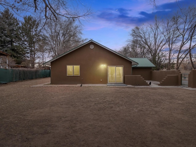 view of back house at dusk