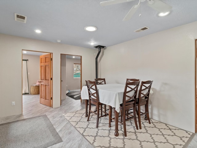 dining room with ceiling fan and light wood-type flooring