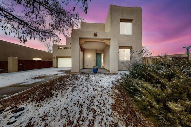 pueblo-style house with a garage