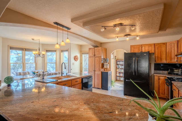 kitchen with arched walkways, light tile patterned floors, a sink, a textured ceiling, and black appliances