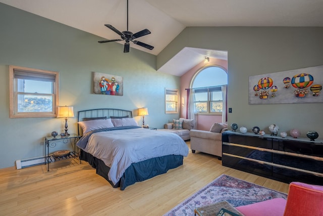 bedroom featuring a baseboard heating unit, lofted ceiling, ceiling fan, and wood finished floors