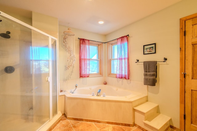 bathroom featuring a stall shower, tile patterned flooring, and a bath