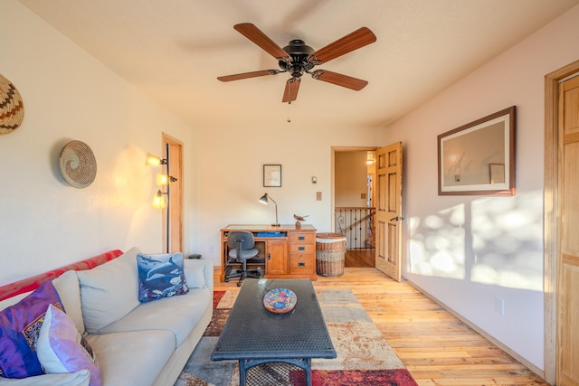 living area with ceiling fan and light wood-style floors