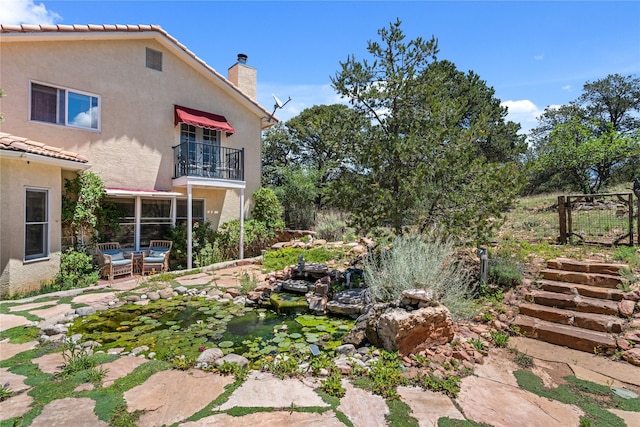 view of yard with a patio area and a balcony