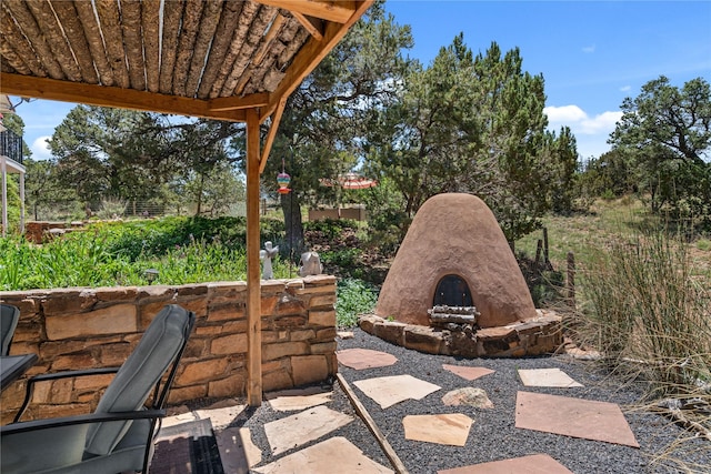 view of patio / terrace with an outdoor stone fireplace