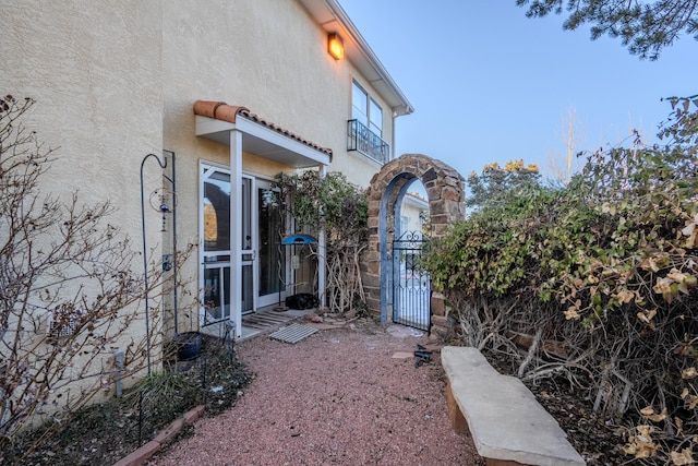 view of property exterior featuring a gate and stucco siding