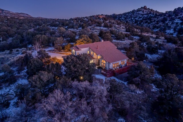 aerial view at dusk featuring a mountain view