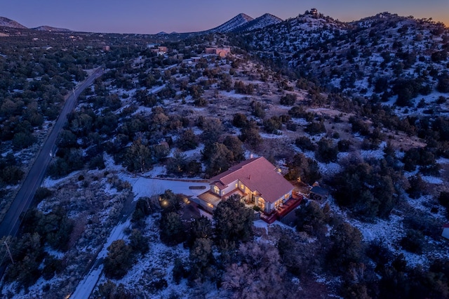 aerial view at dusk featuring a mountain view