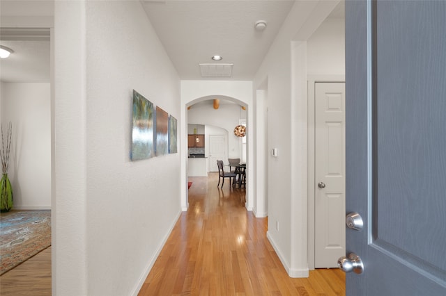 hall featuring a textured ceiling and light wood-type flooring