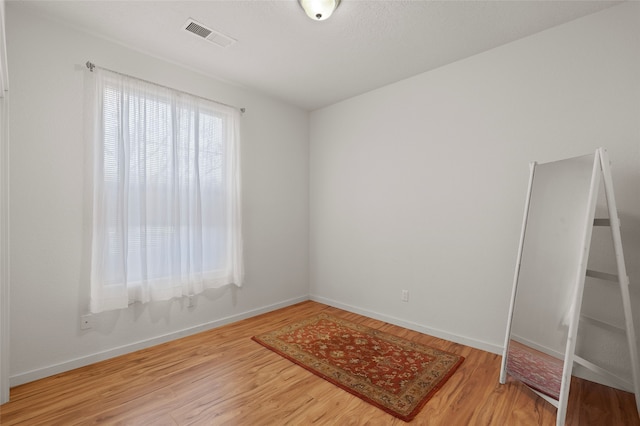 spare room with wood-type flooring