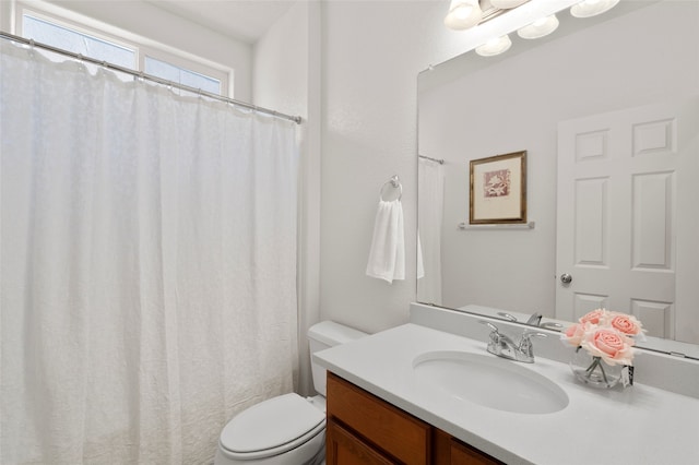 bathroom with toilet and vanity