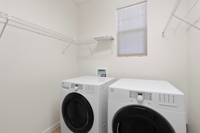 washroom featuring washer and dryer and tile patterned flooring