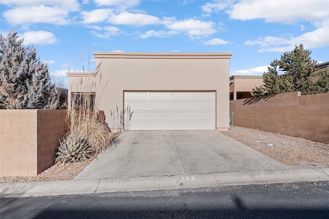 pueblo-style home with a garage