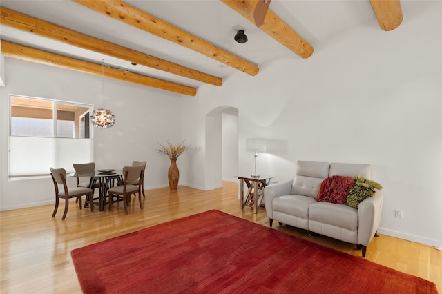 living room featuring wood-type flooring and beam ceiling