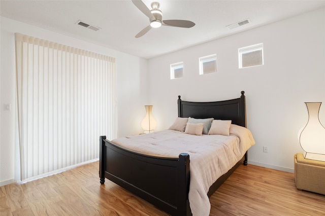 bedroom with ceiling fan and light hardwood / wood-style flooring