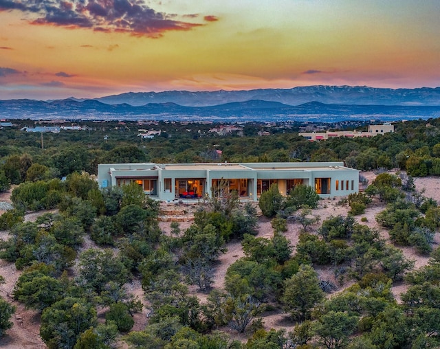 aerial view at dusk featuring a mountain view