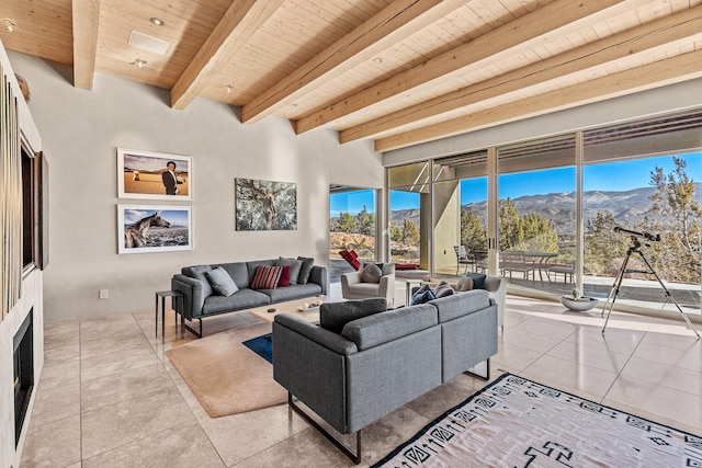 tiled living room with wood ceiling, beam ceiling, and a mountain view