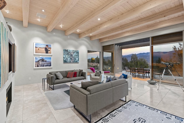 living room featuring a mountain view, wood ceiling, beamed ceiling, and light tile patterned floors