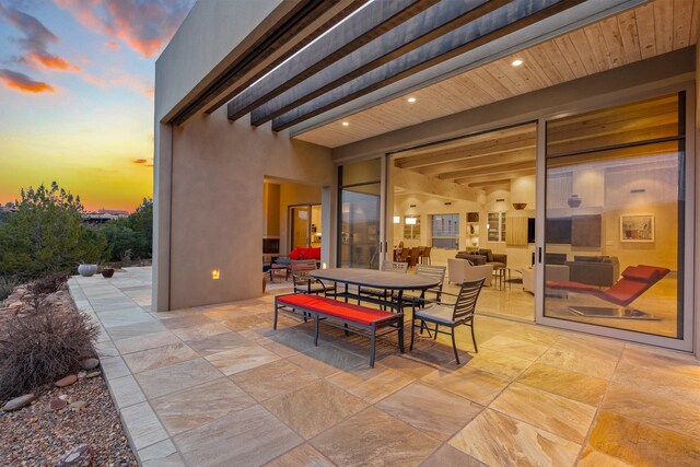 view of patio terrace at dusk