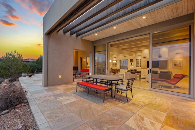 view of patio terrace at dusk