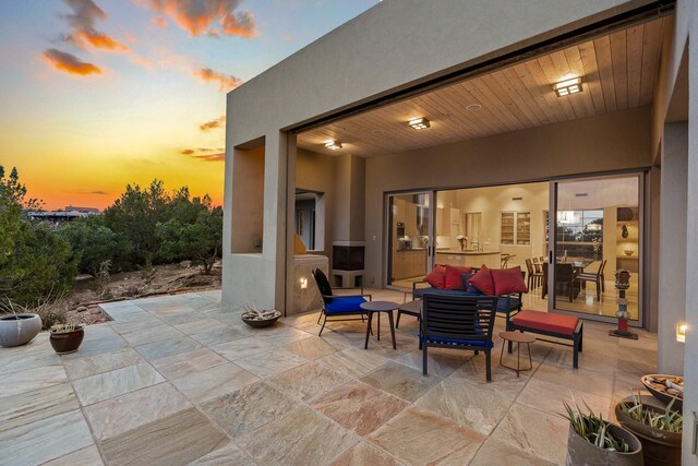 patio terrace at dusk featuring outdoor lounge area