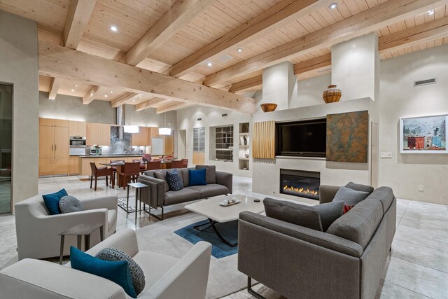 living room featuring a towering ceiling, wood ceiling, and beam ceiling