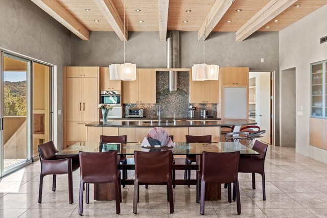 dining room with a towering ceiling, beamed ceiling, and wood ceiling