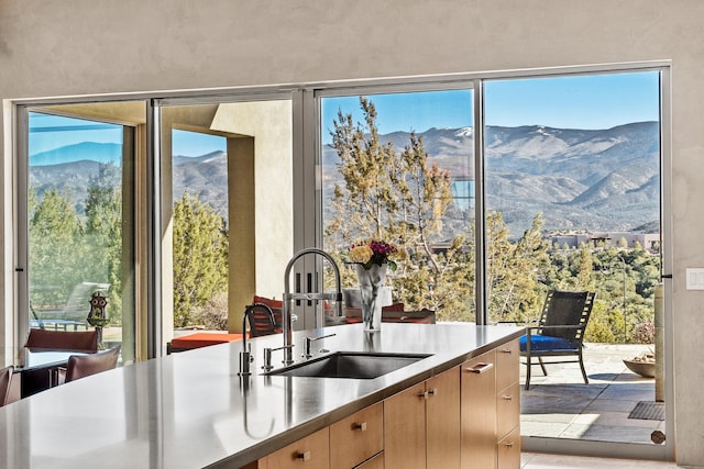 kitchen featuring a mountain view and sink