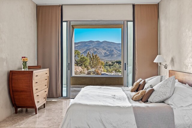 bedroom featuring access to outside and a mountain view