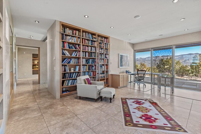 living area featuring light tile patterned floors and a mountain view