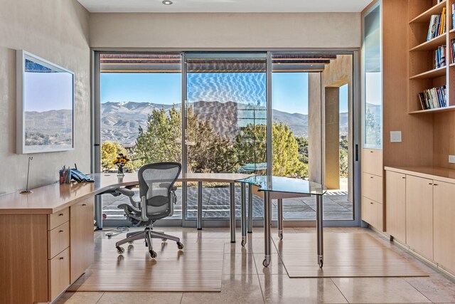 home office with light tile patterned flooring and a mountain view