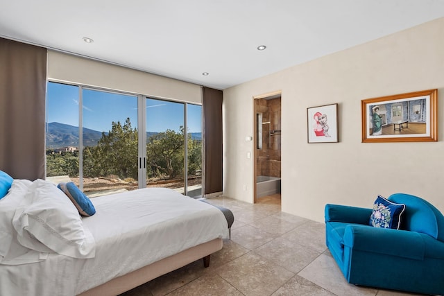 bedroom with a mountain view, ensuite bath, and access to exterior