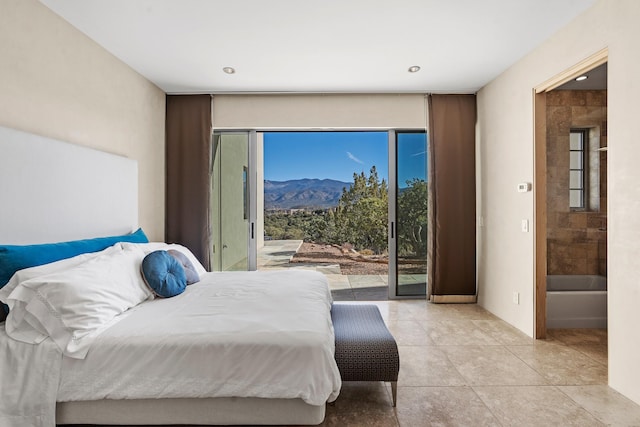 bedroom featuring access to exterior, light tile patterned floors, and a mountain view