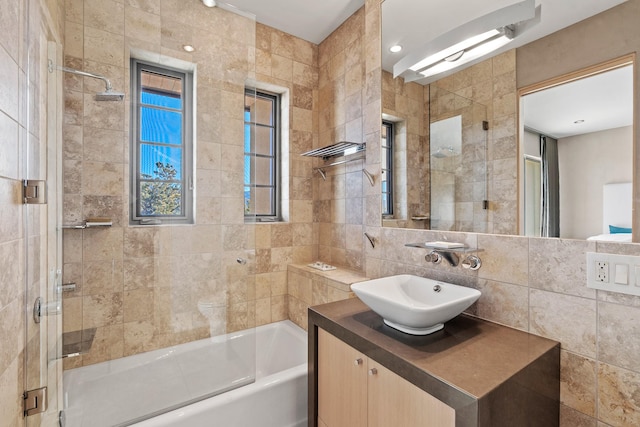 bathroom with vanity, tile walls, and decorative backsplash